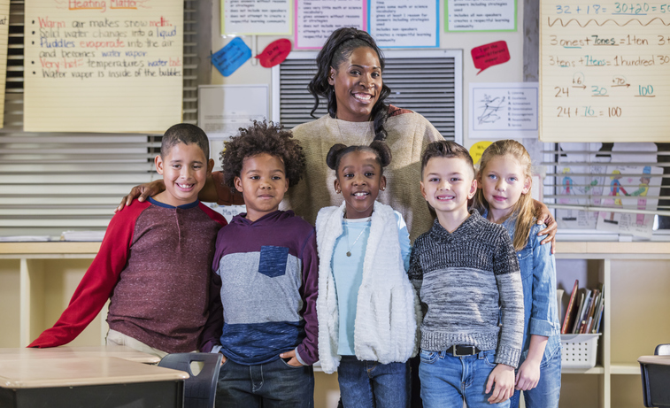Multi-ethnic elementary students, teacher in classroom
