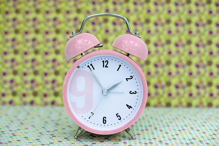 pink alarm clock in vintage background