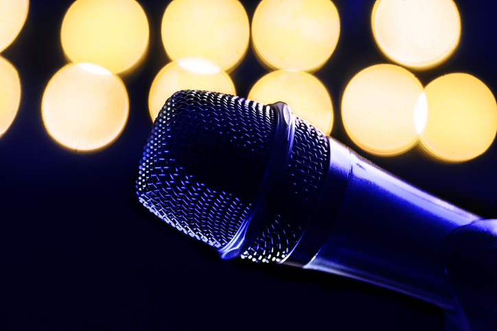 Close-up of microphone and stage lights